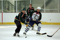 Chris Newans looks on as UAA Seawolf Ryan McMullen and UAH Charger Jackson Harren Chris Newans looks on as UAA Seawolf Ryan McMullen and UAH Charger Jackson Harren