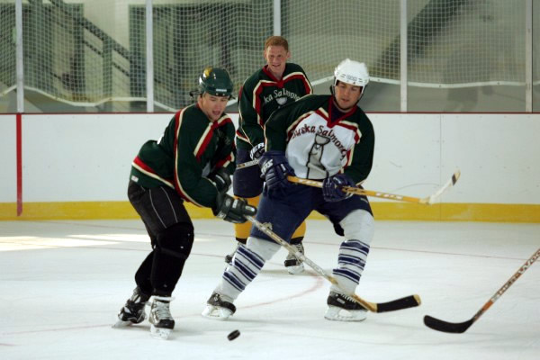 Chris Newans looks on as UAA Seawolf Ryan McMullen and UAH Charger Jackson Harren
