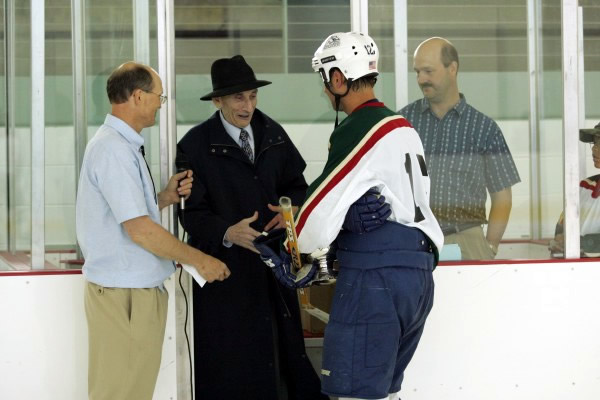 Retired UAF Professor Sarkis Atamian presents shootout champion Jackson Harren with the Atamian Cup!
