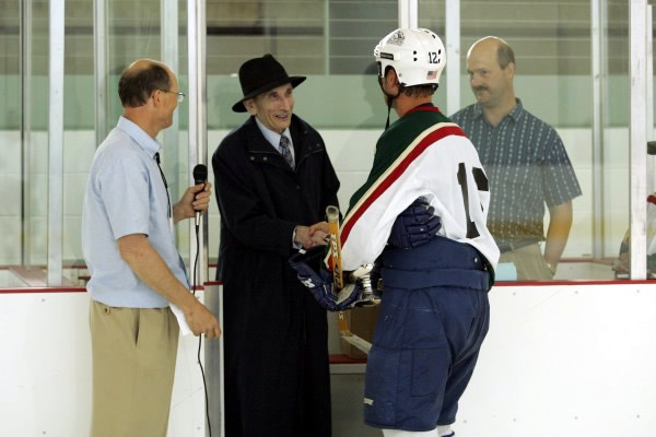 Retired UAF Professor Sarkis Atamian presents shootout champion Jackson Harren with the Atamian Cup!